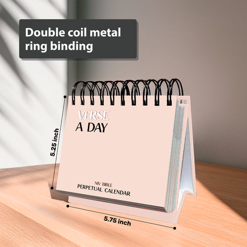 The HannahFaithstore Religious Perpetual Calendar, spiral-bound with a double coil metal ring, stands on a wooden surface and measures 5.25 by 5.75 inches.