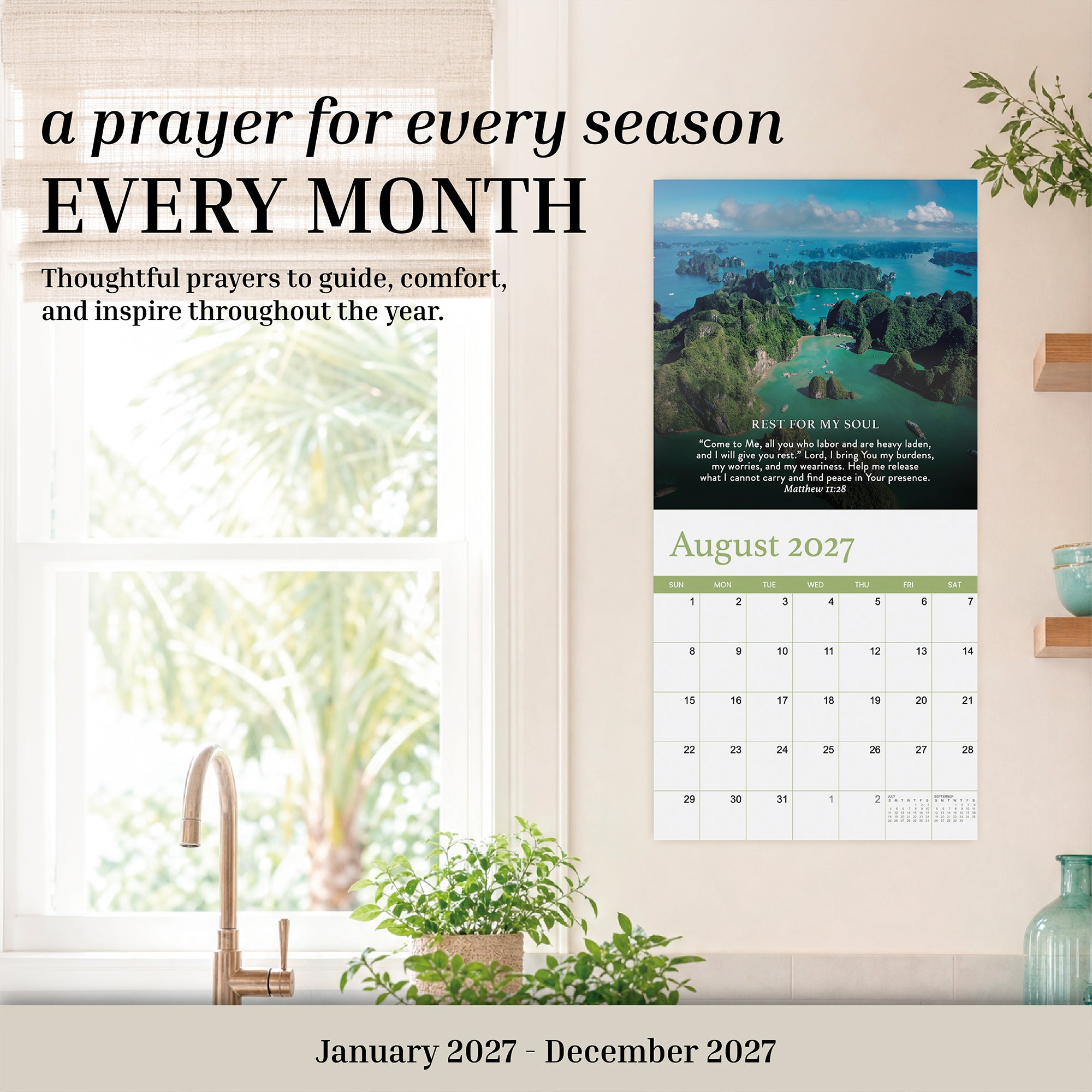 The 2027 Prayer Wall Calendar by HannahFaithstore is a faith-based calendar featuring monthly prayers and inspiring nature photography. The August page highlights tropical scenery, making it a thoughtful Bible verse calendar gift—perfectly displayed above your desk with plant decor on a beige wall.