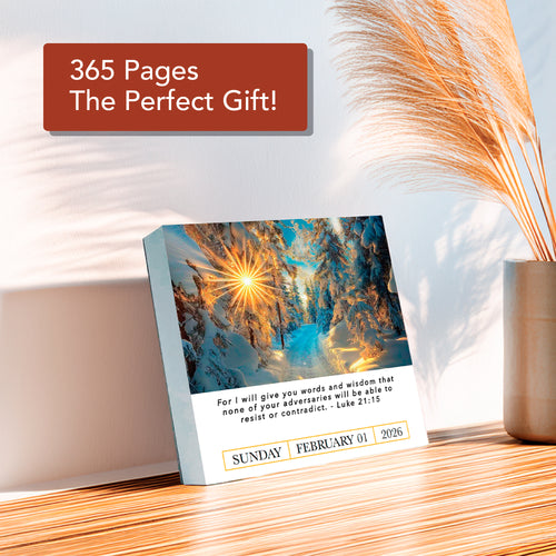 The 2026 A Verse A Day Calendar by HannahFaithstore shows a winter scene and Bible verse for Sunday, February 1, 2026, set on a wooden surface with dry grass in a vase and a sign above.