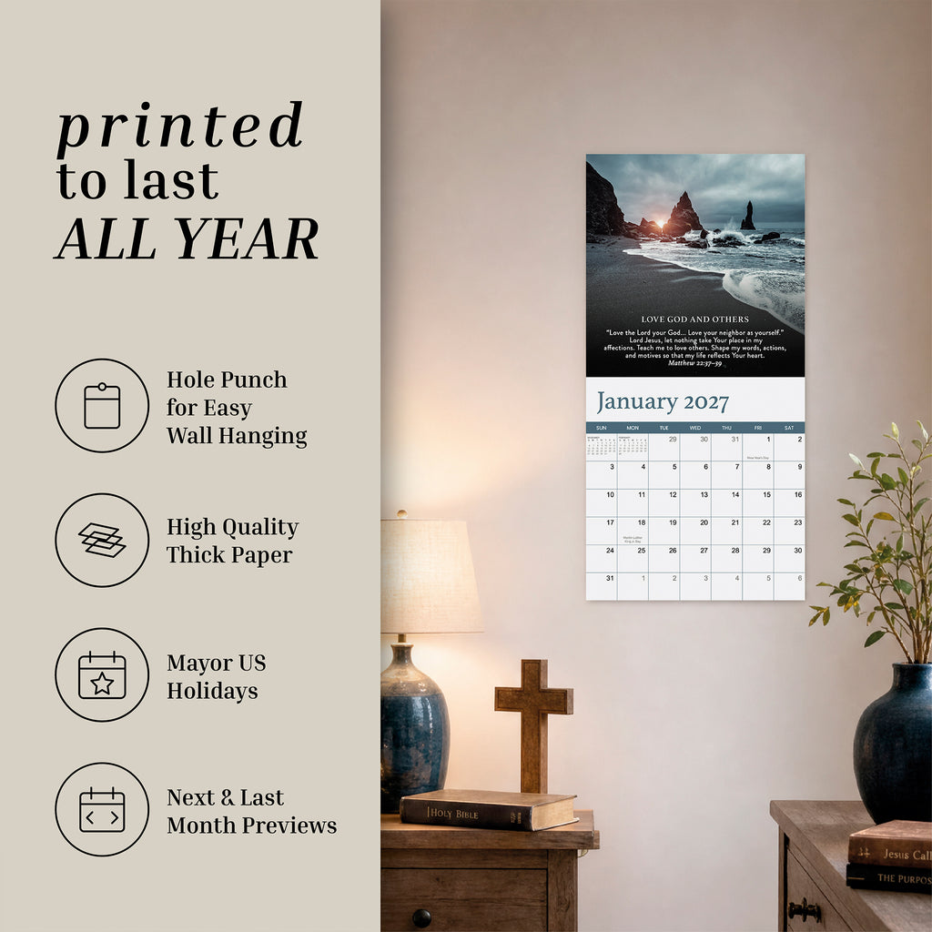 The 2027 Prayer Wall Calendar from HannahFaithstore is displayed above a lamp on a beige wall, with its features—including a hole punch for easy hanging, thick paper, US holidays, and monthly previews—listed to the left. This beautifully designed Bible verse calendar offers inspiration each month and helps you stay organized all year, making it an ideal faith-based gift.