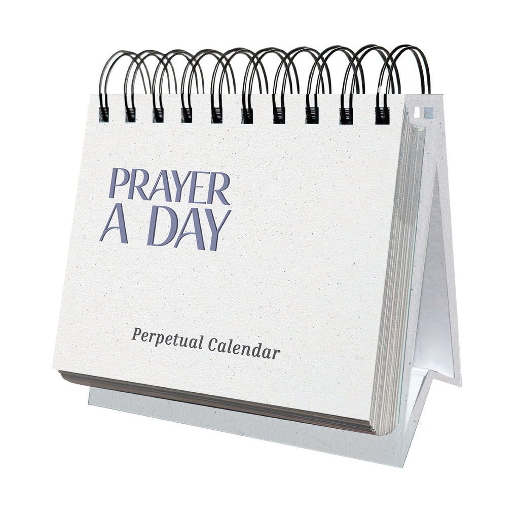 A white spiral-bound "Perpetual Prayer A Day Calendar" by HannahFaithstore is displayed standing on a desk.
