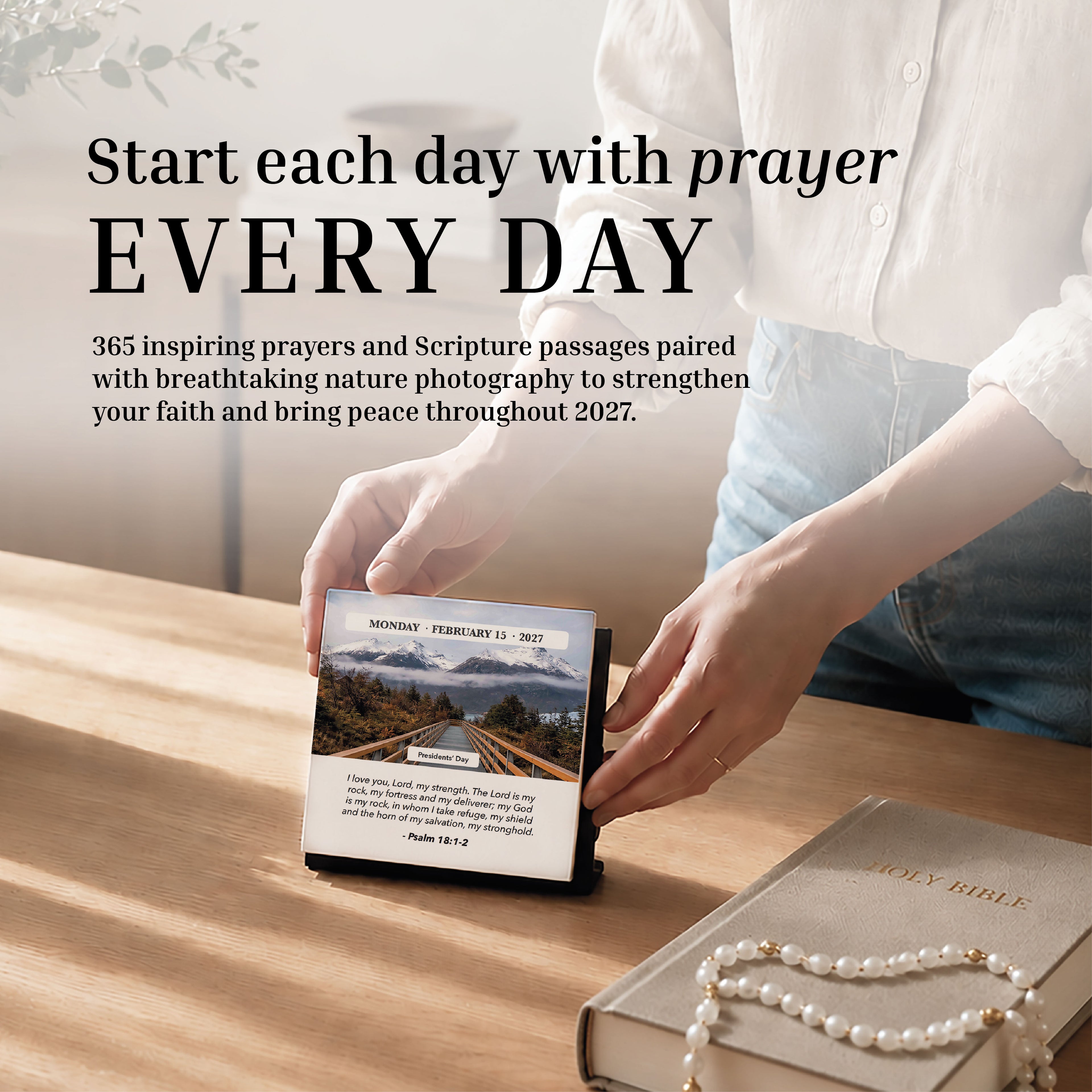 A person opens the HannahFaithstore 2027 A Verse A Day Calendar beside a tan Holy Bible and pearl bracelet on a bright wooden table, seeking mindful daily inspiration through scripture.