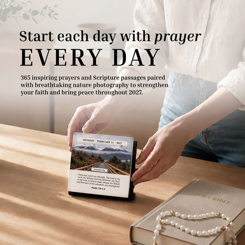 A person opens the HannahFaithstore 2027 A Verse A Day Calendar beside a tan Holy Bible and pearl bracelet on a bright wooden table, seeking mindful daily inspiration through scripture.